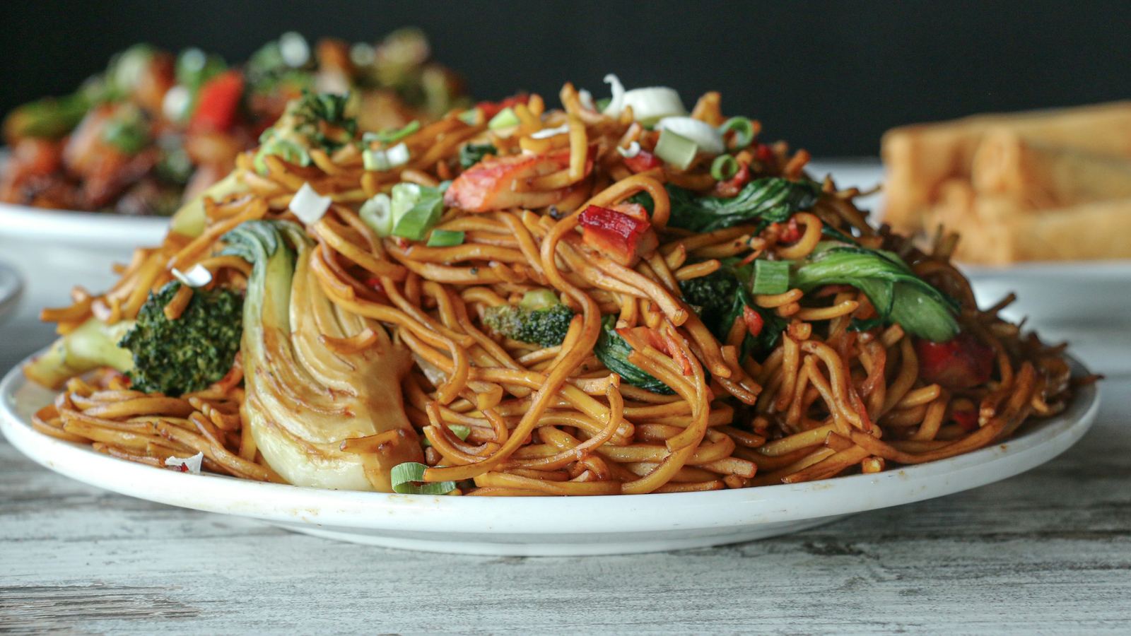 A plate of noodles stir-fried with broccoli and other vegetables